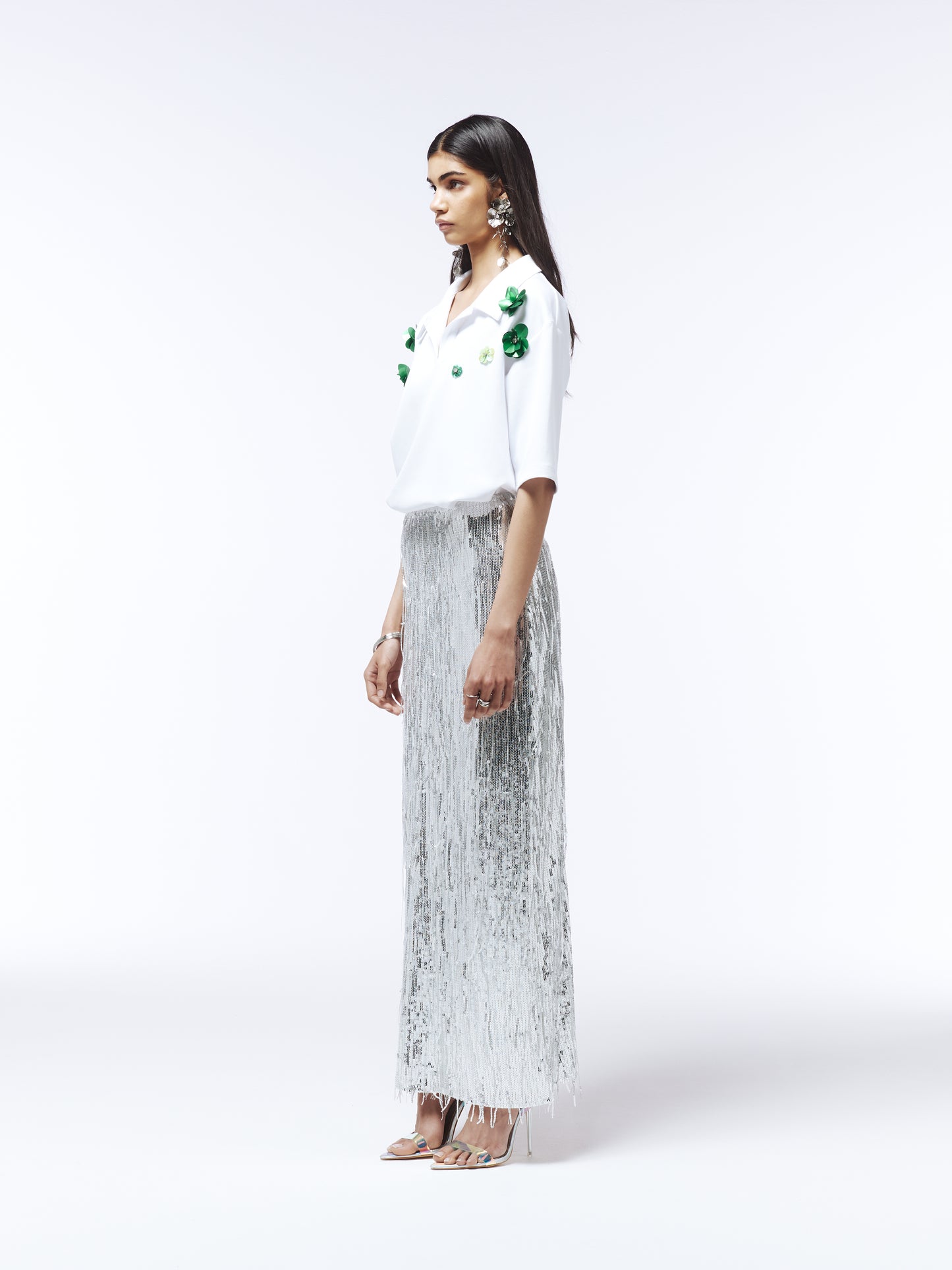 White collared blouse featuring 3D green flower embroidery on chest