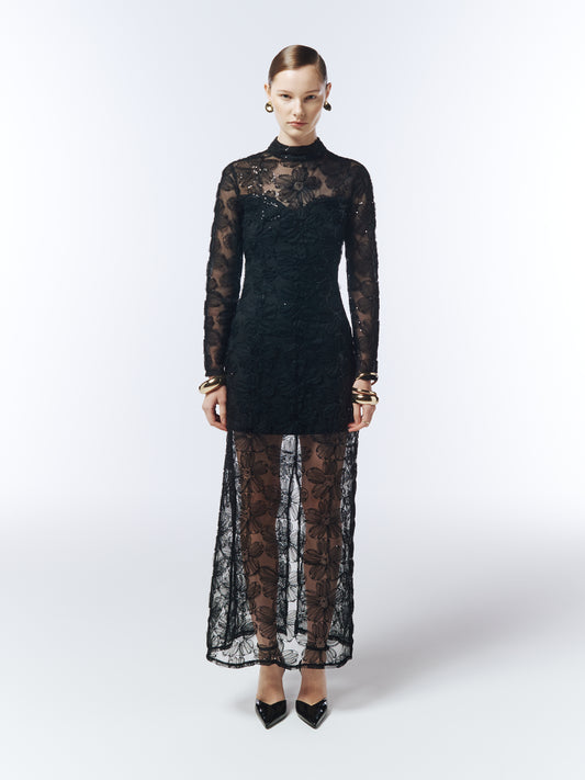 Model wearing SOUR FIGS 3D Floral Embroidered Mesh Evening Dress in Black with long sheer sleeves and tonal sequin details.