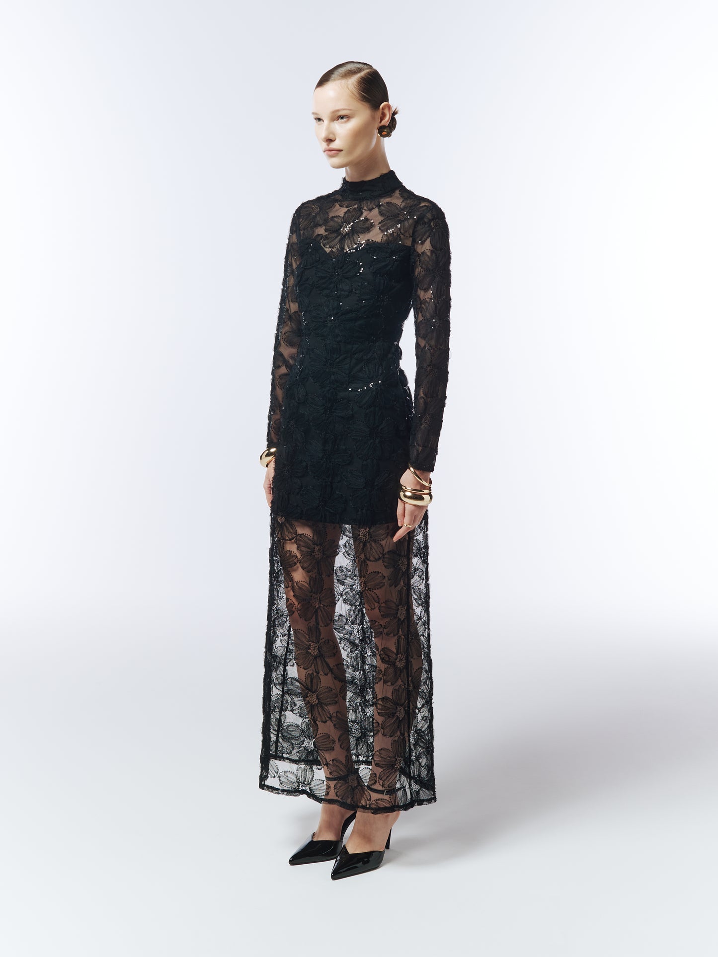 Side profile showcasing sheer embroidered overlay and sculpted column silhouette.
