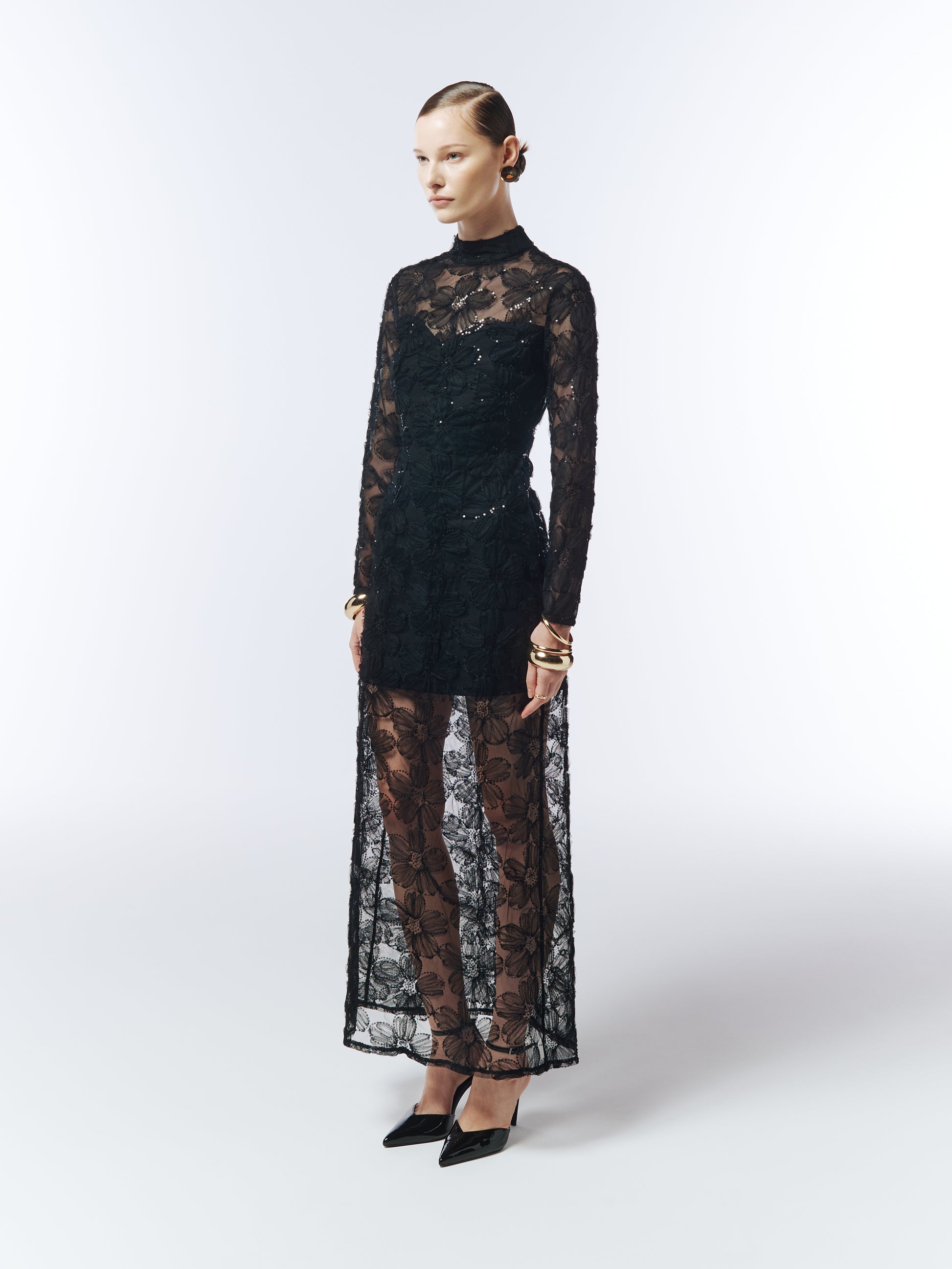 Side profile showcasing sheer embroidered overlay and sculpted column silhouette.