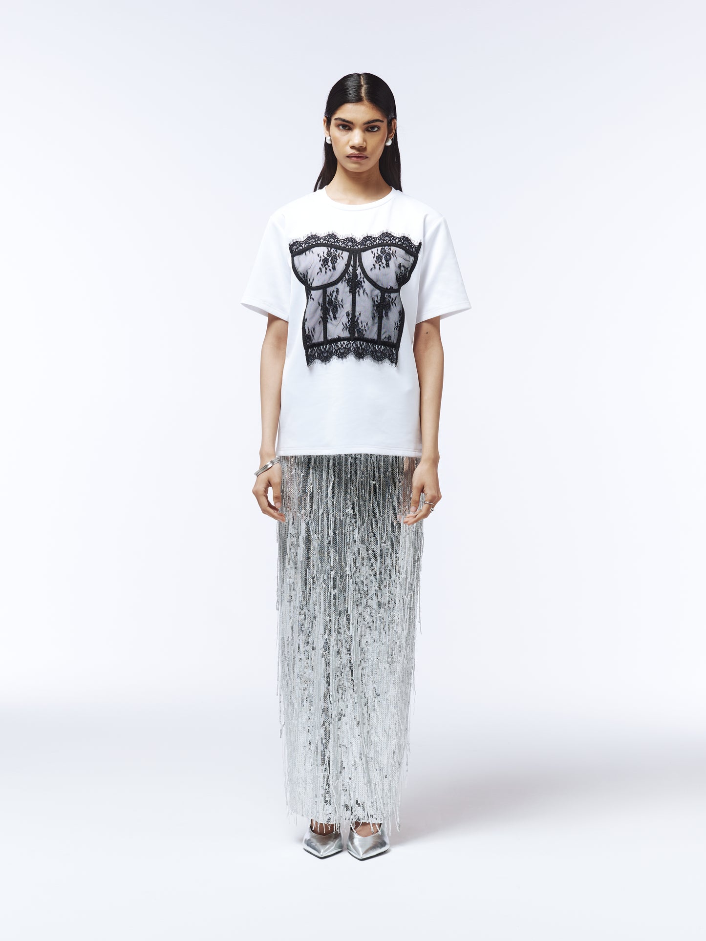 Model wearing short-sleeve T-shirt with sheer lace corset detailing