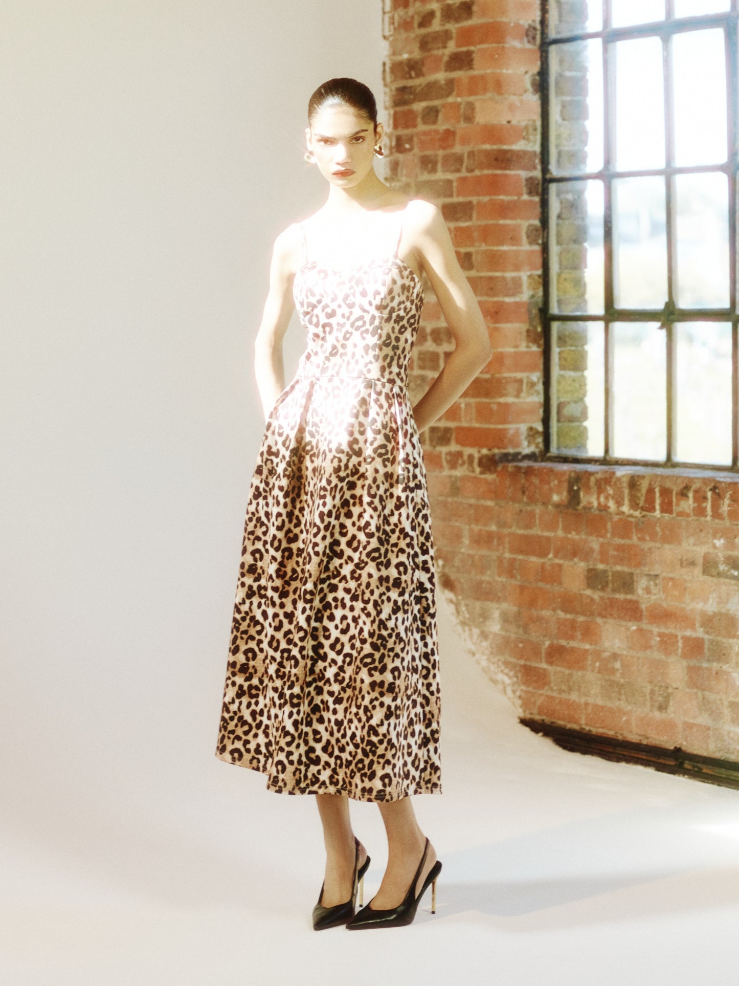 SOUR FIGS animal-print midi dress with an A-line silhouette, styled for luxury editorial setting.