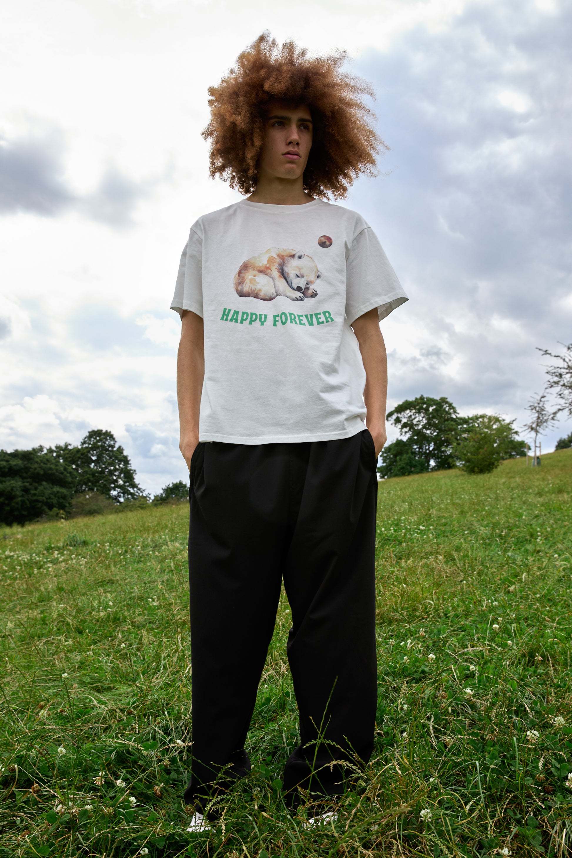 Cute bear graphic tee with pastel planet and positive message by SOUR FIGS.