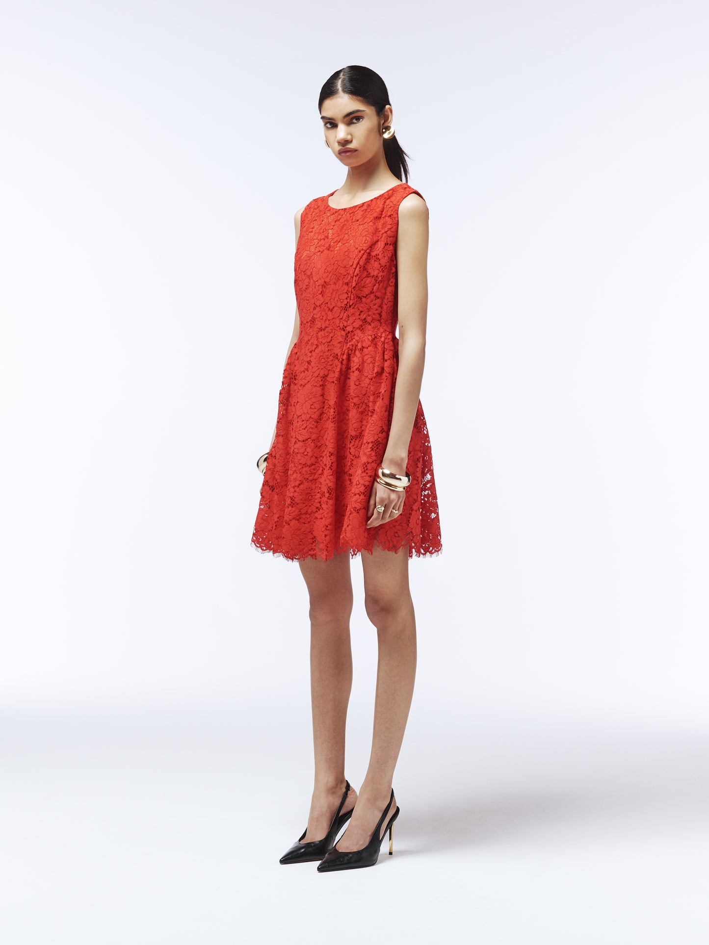 Back view of red lace cocktail dress featuring scalloped hem and tailored waist