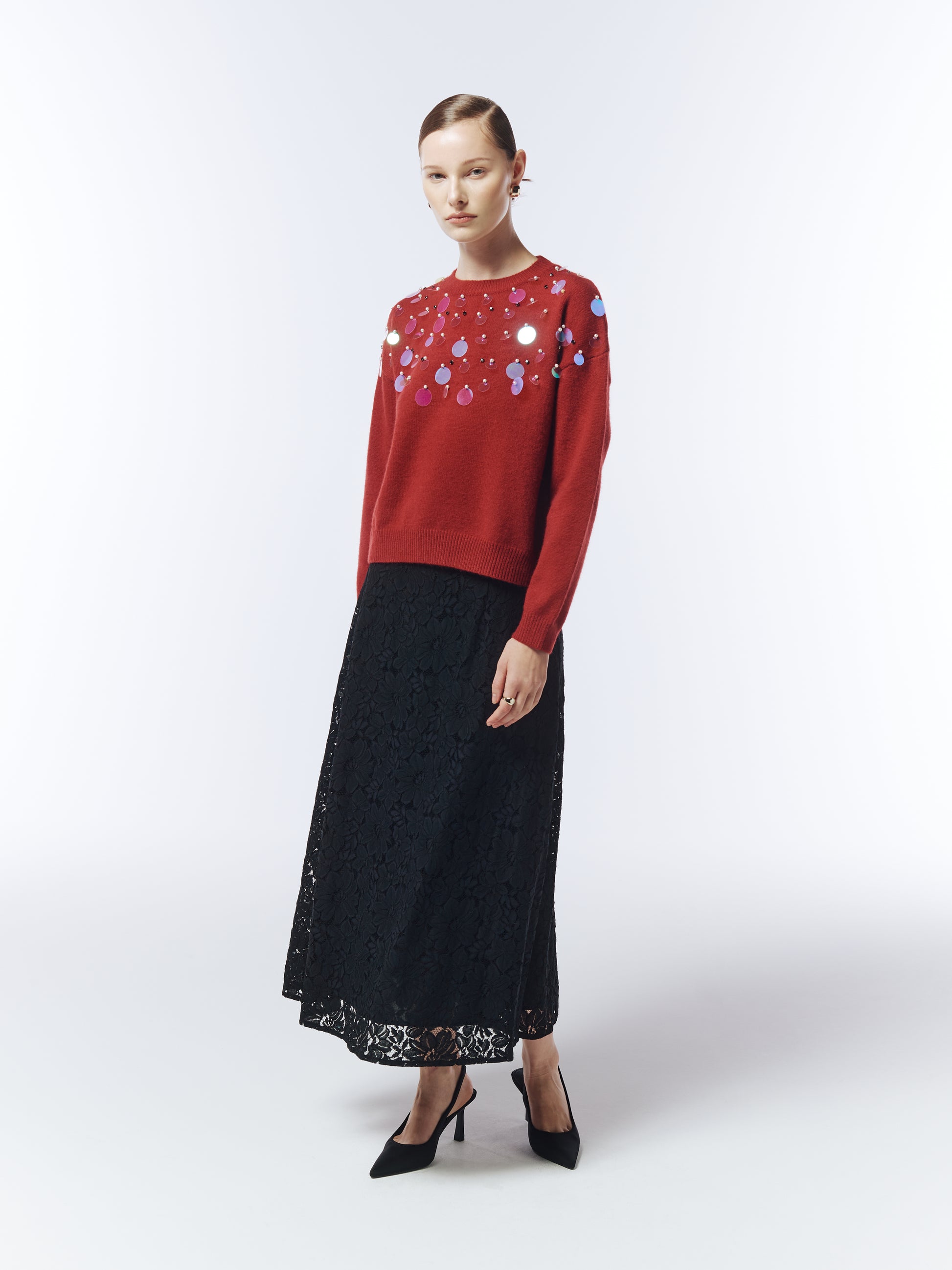 Model wearing SOUR FIGS Sequin-Embellished Jumper in burgundy red with black lace skirt.
