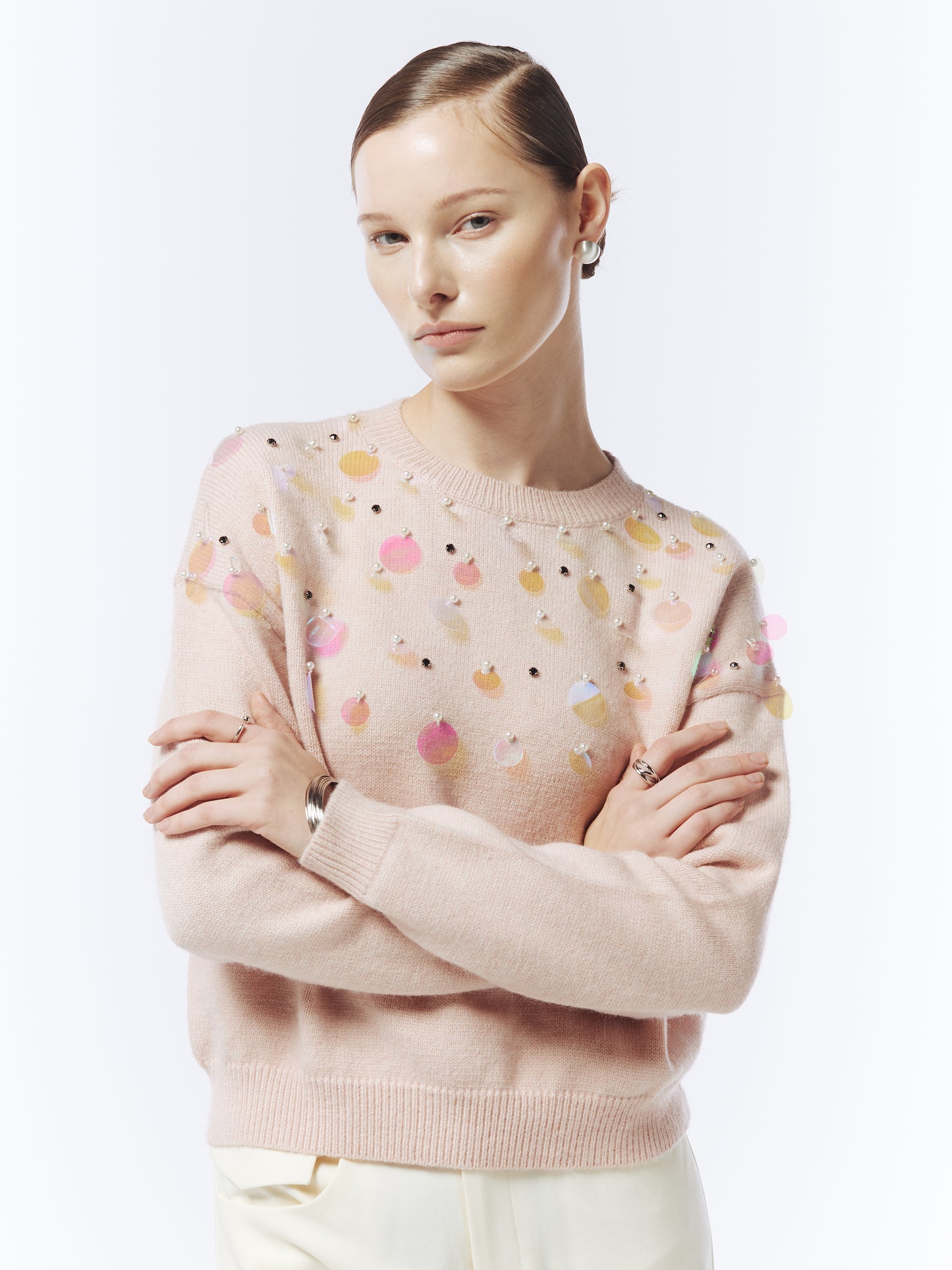 Close-up of iridescent sequin embellishments on SOUR FIGS pink jumper