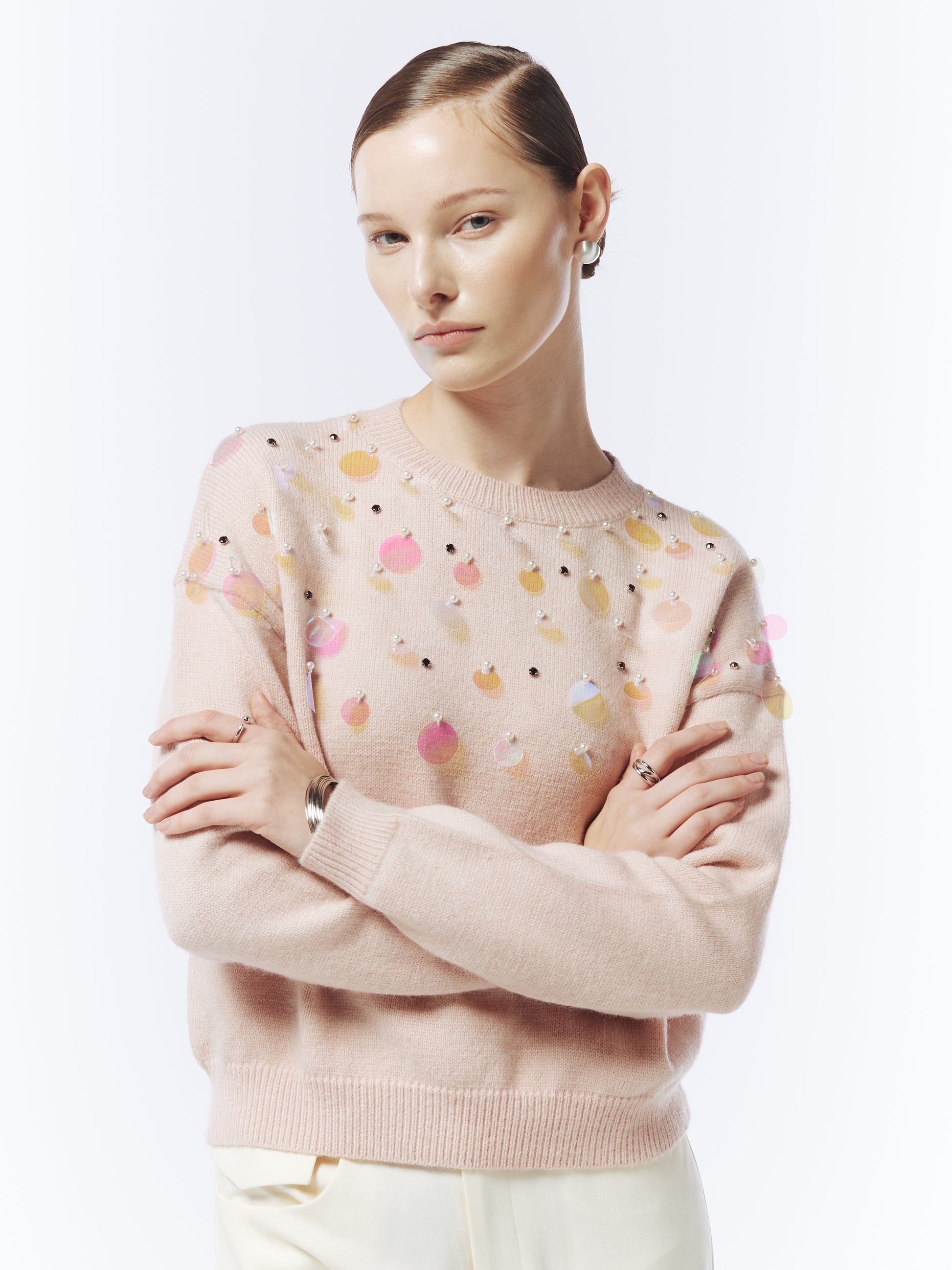 Close-up of iridescent sequin embellishments on SOUR FIGS pink jumper