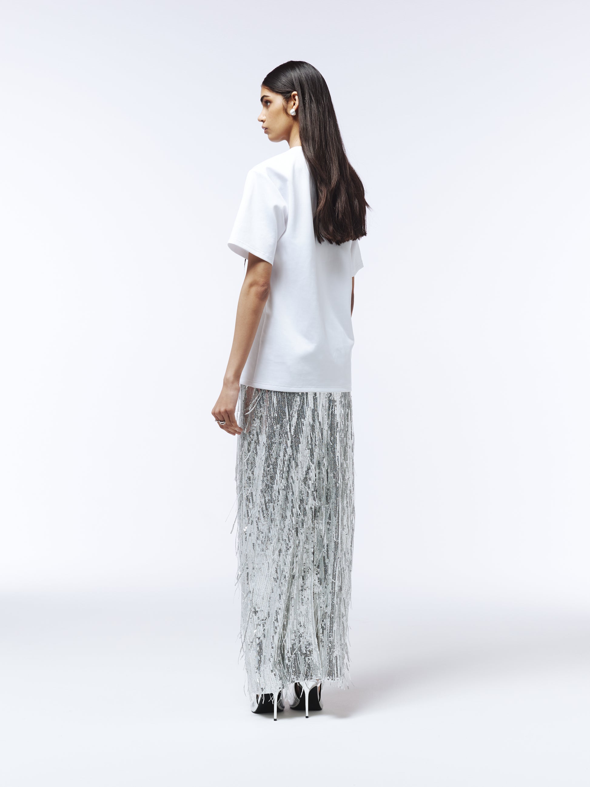 Lace-appliquéd white T-shirt styled with tailored trousers