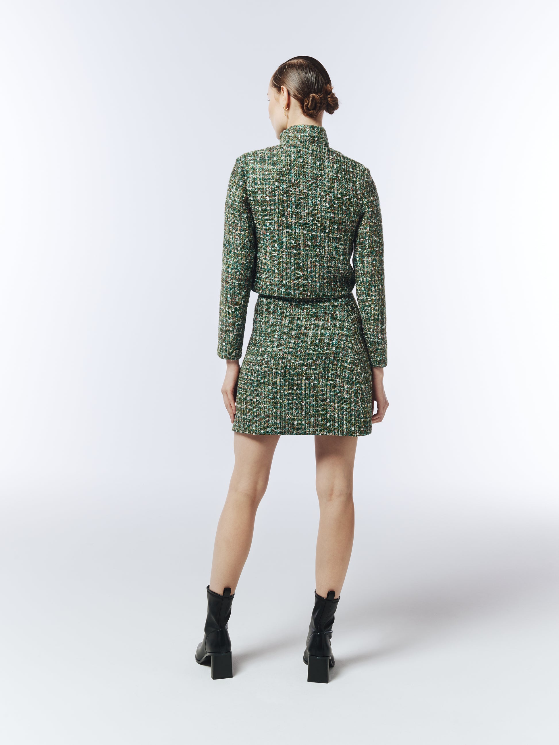 Back view of SOUR FIGS emerald tweed mini skirt styled with boots.