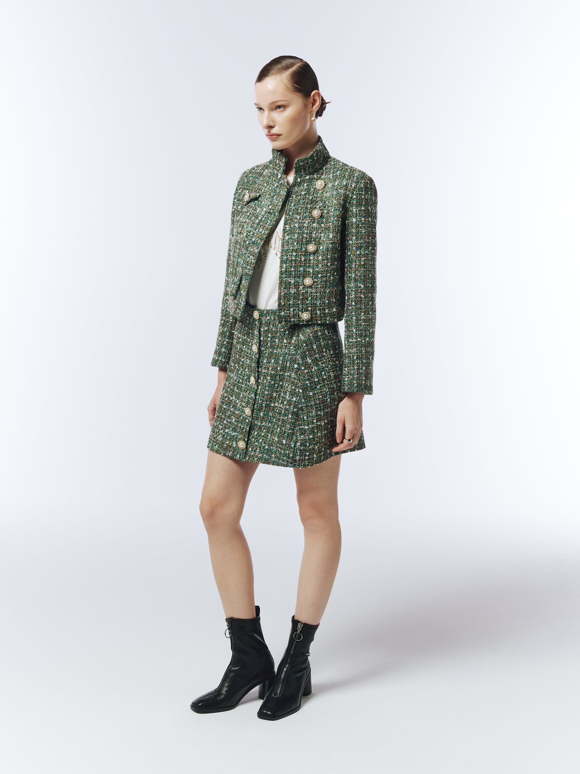 Side view of SOUR FIGS multi-tonal tweed skirt showing pearl-button detail.