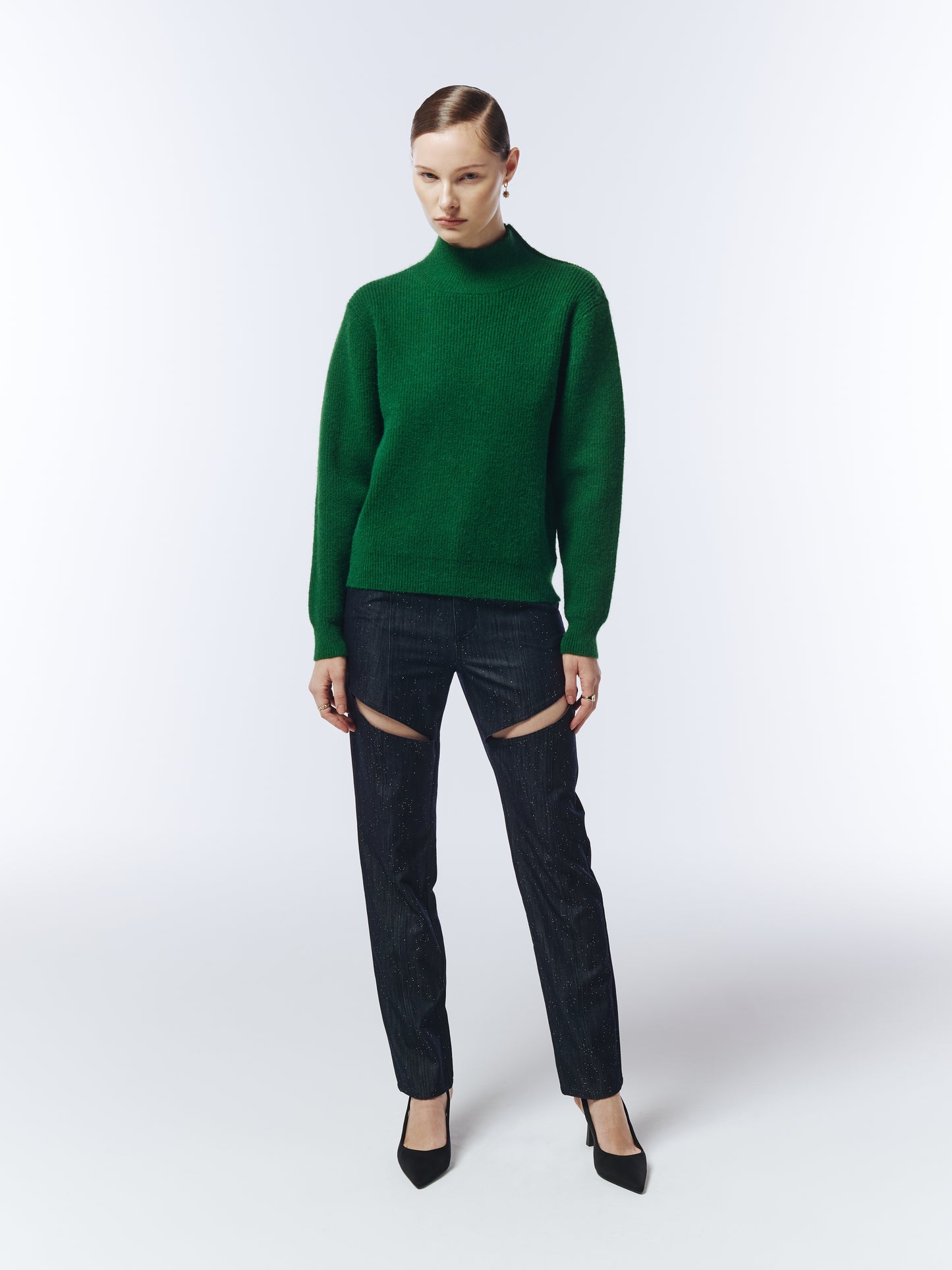 Model wearing SOUR FIGS Gold-Button Shoulder Jumper in Pine Green with dark trousers.