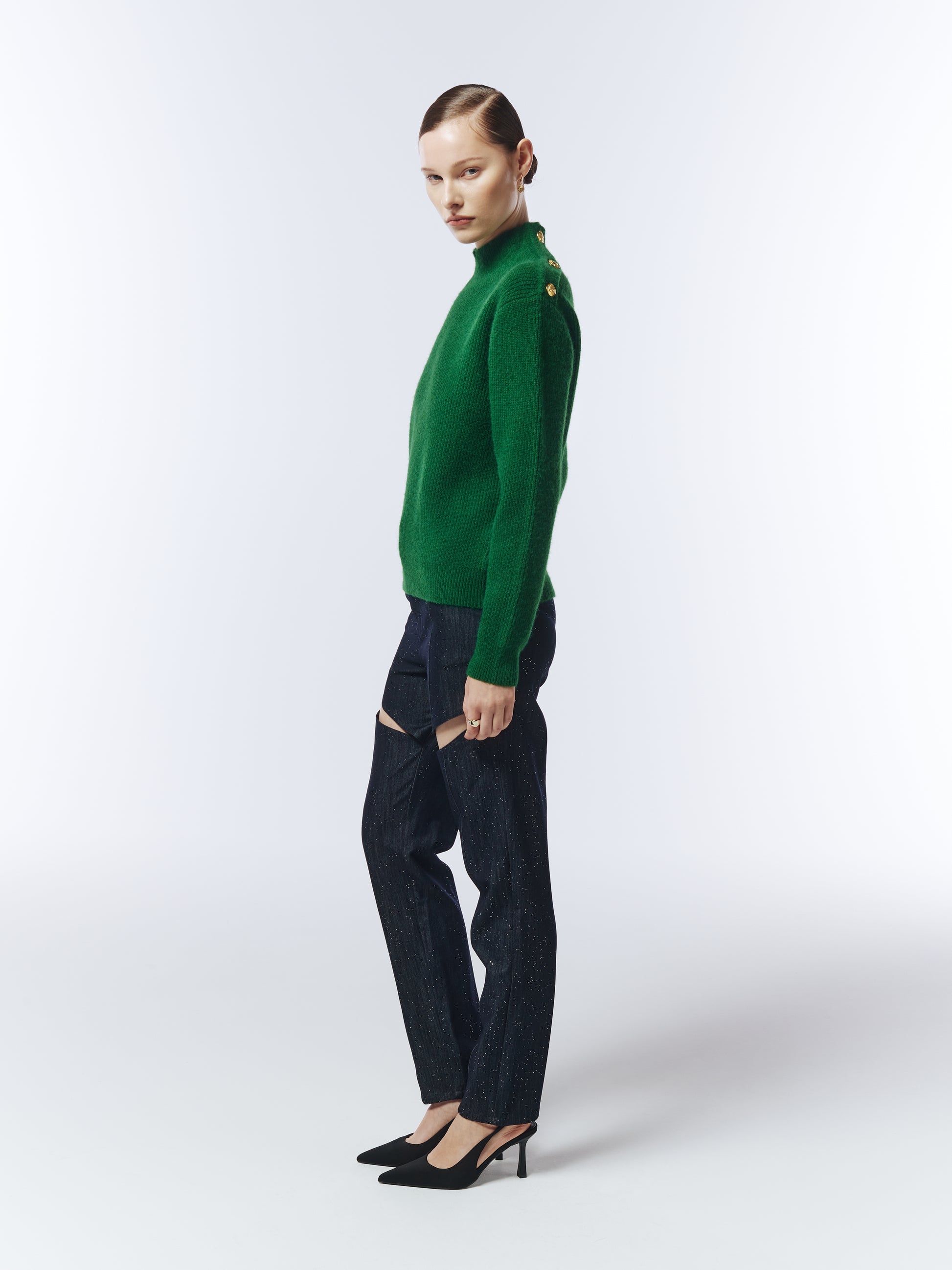 Side profile of pine green jumper showing gold shoulder buttons.