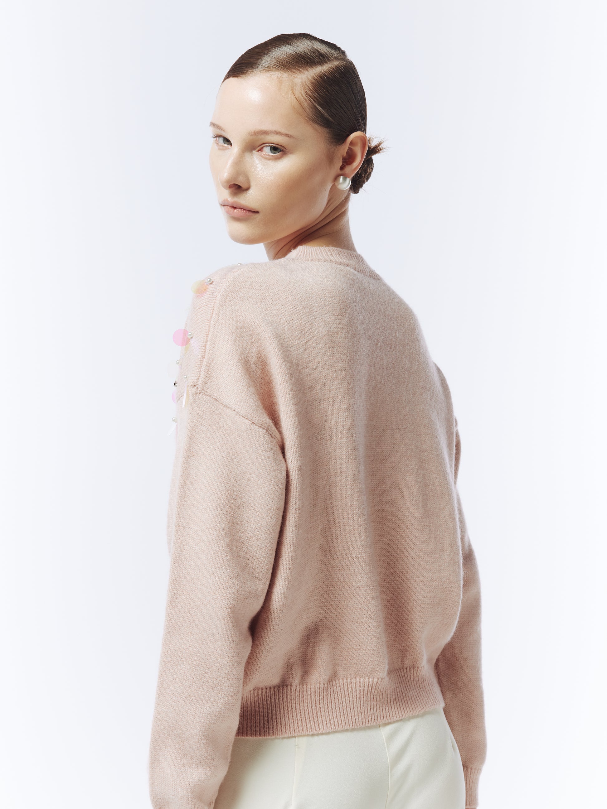 Back view of SOUR FIGS pink jumper highlighting relaxed silhouette and ribbed hem.