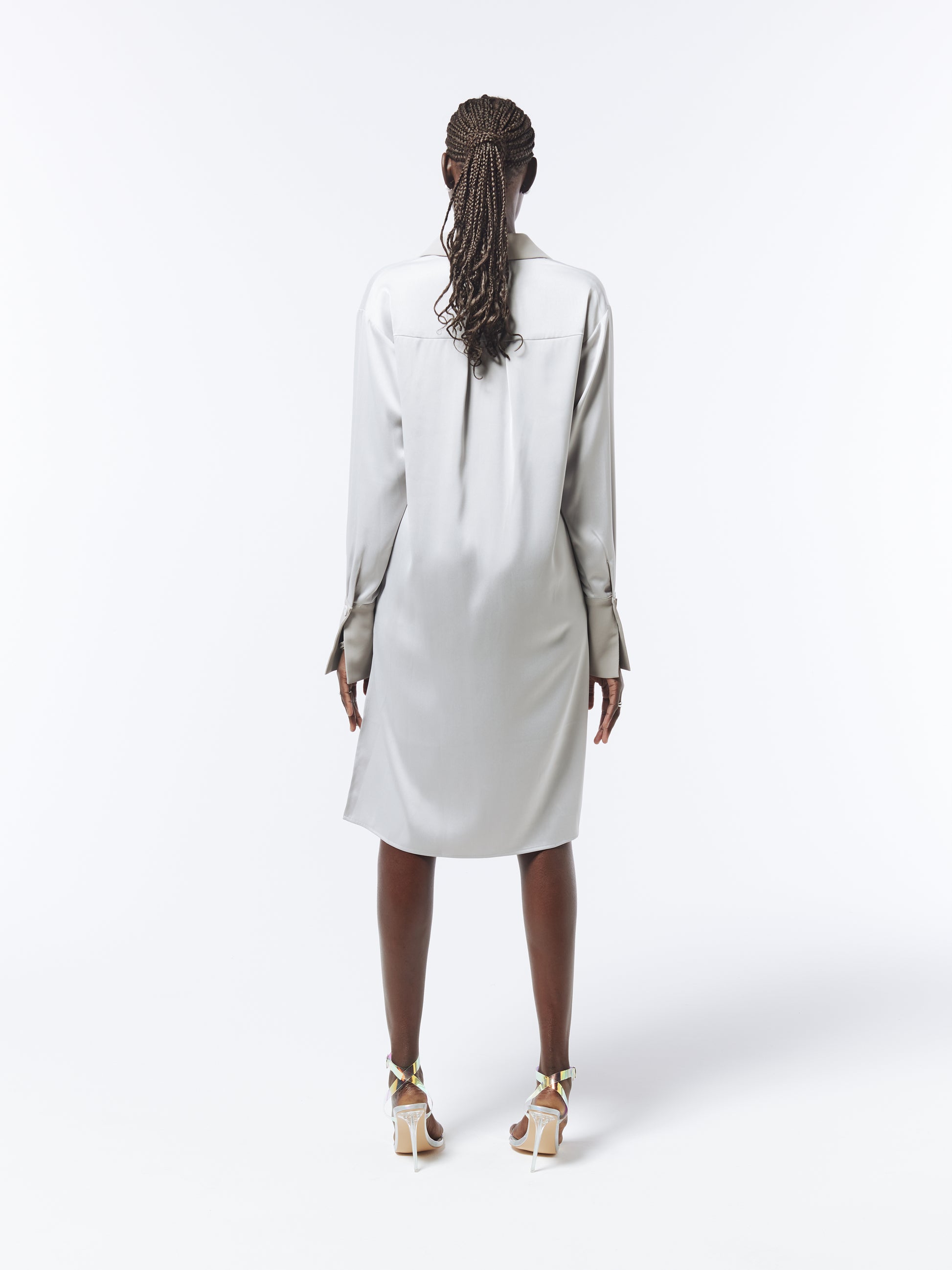 Silver satin shirt dress with asymmetric hem by SOUR FIGS – a contemporary take on timeless elegance.