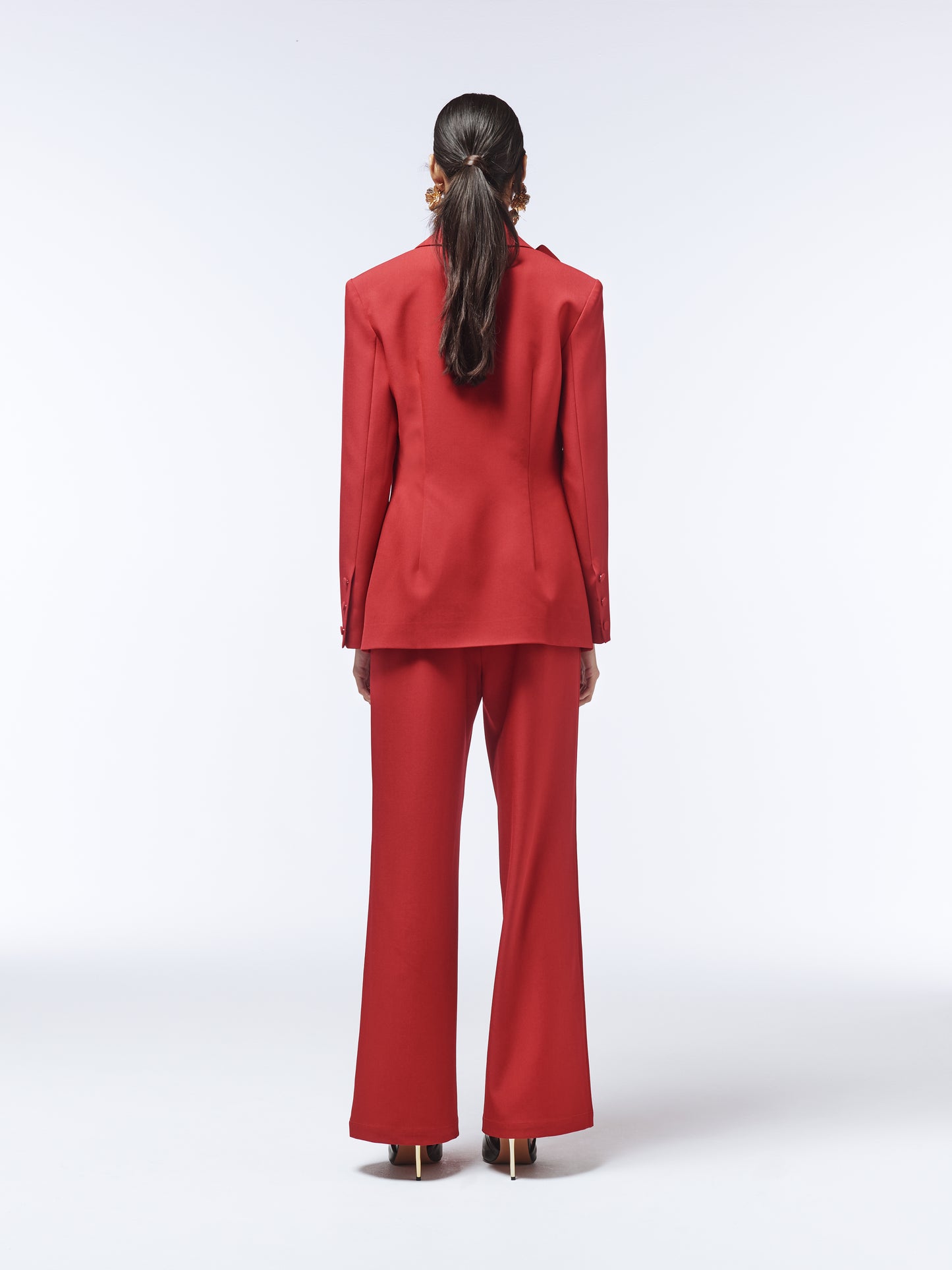 Back view of SOUR FIGS rose-detail blazer with sharp tailoring and contoured seams.