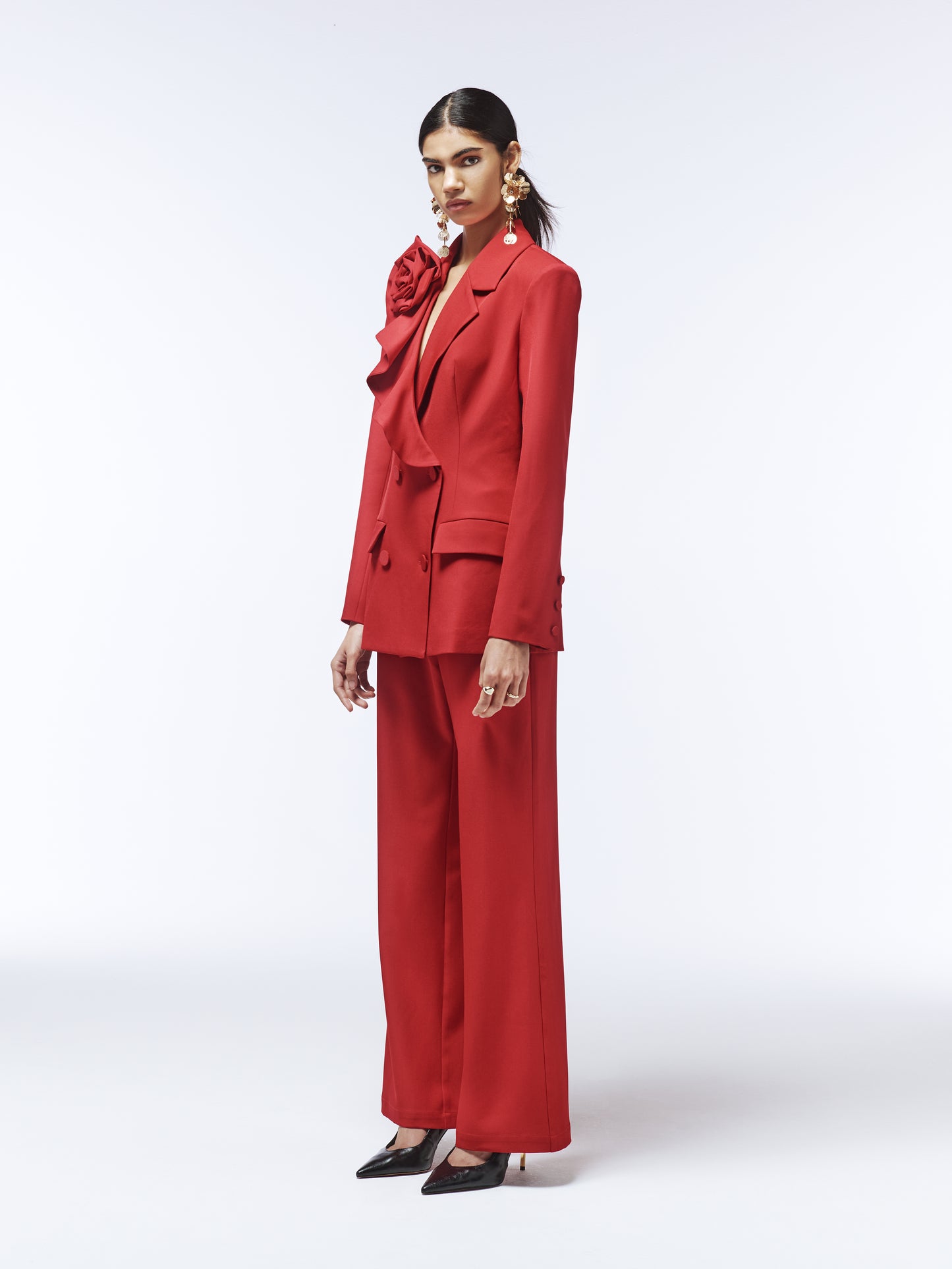 Side view of SOUR FIGS vivid burgundy tailored blazer showing sculptural rose and lapel.