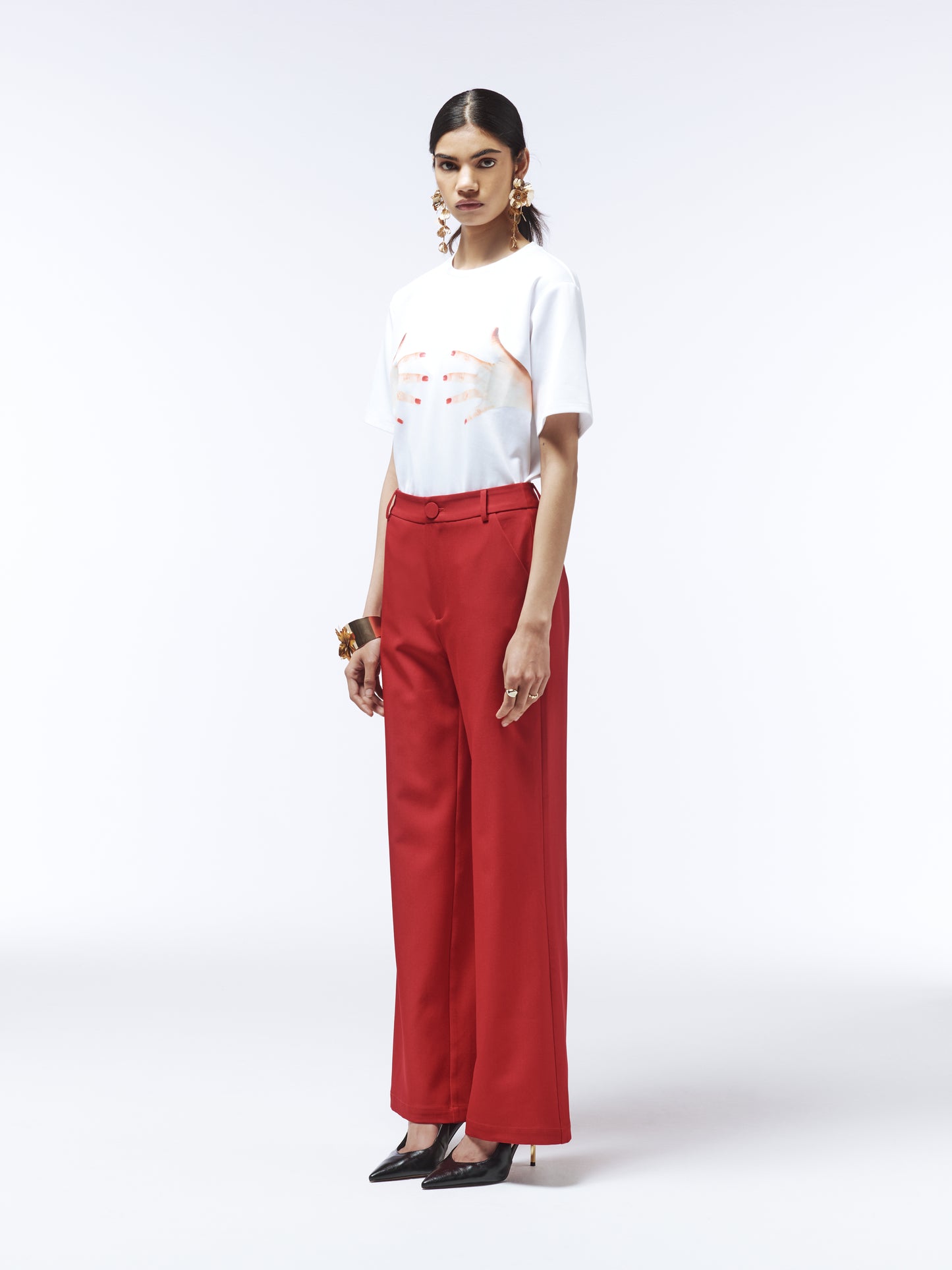 Model wearing SOUR FIGS Tailored High-Waisted Wide-Leg Trousers in Vivid Burgundy Red with white graphic tee.