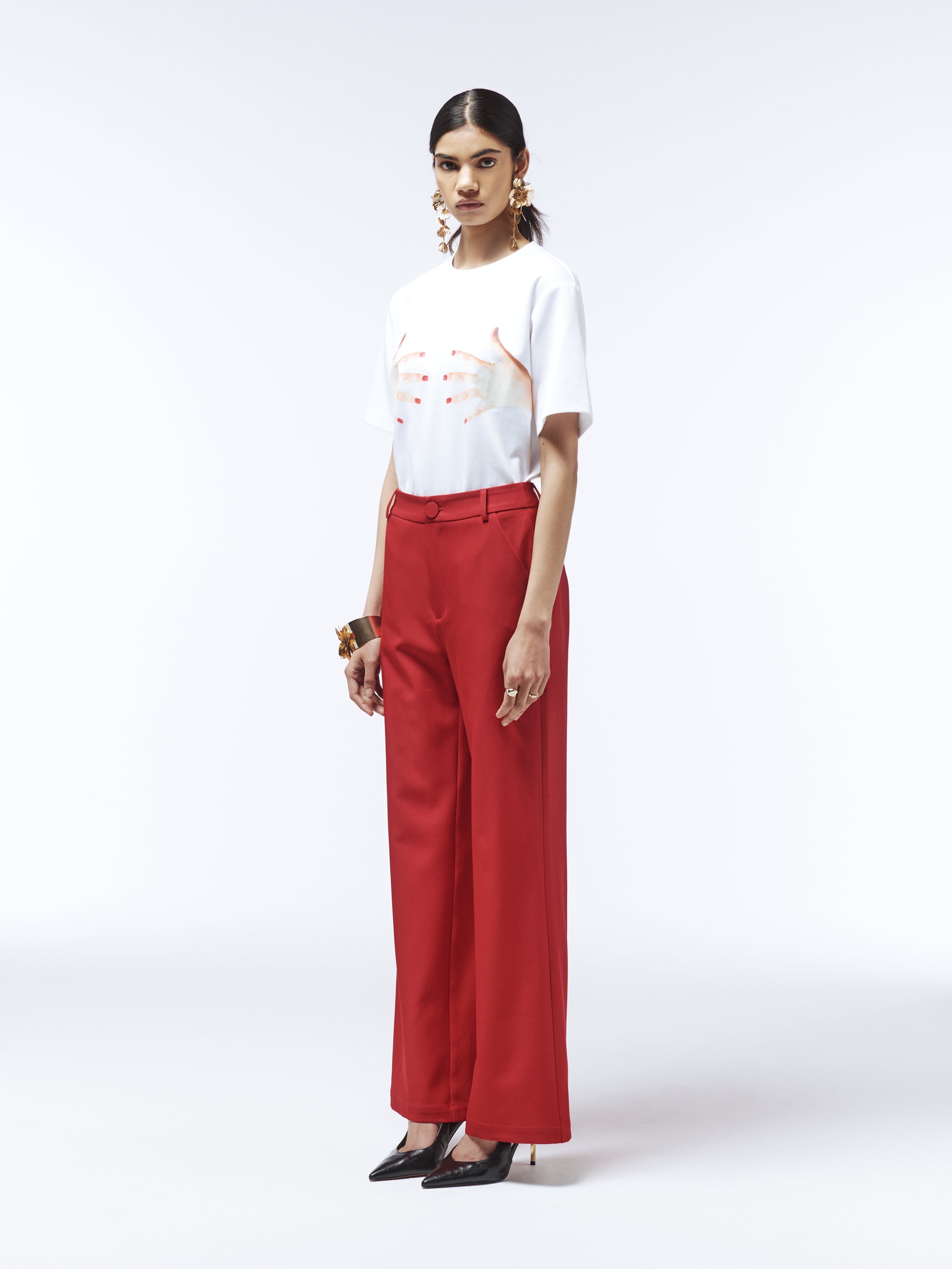 Model wearing SOUR FIGS Tailored High-Waisted Wide-Leg Trousers in Vivid Burgundy Red with white graphic tee.