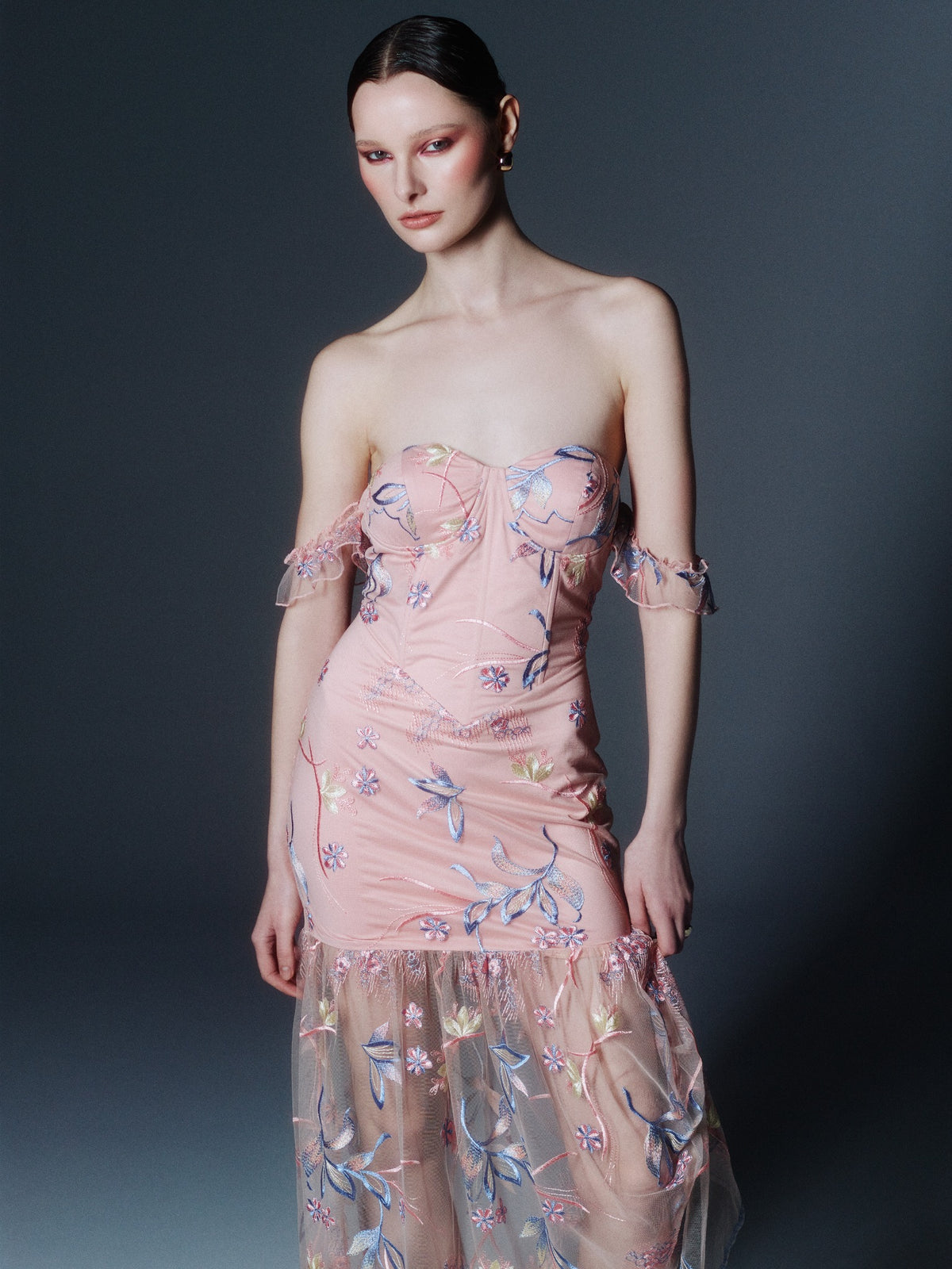 SOUR FIGS blush pink floral-embroidered bustier maxi dress, front model view showing the sweetheart bodice and sheer lower skirt.