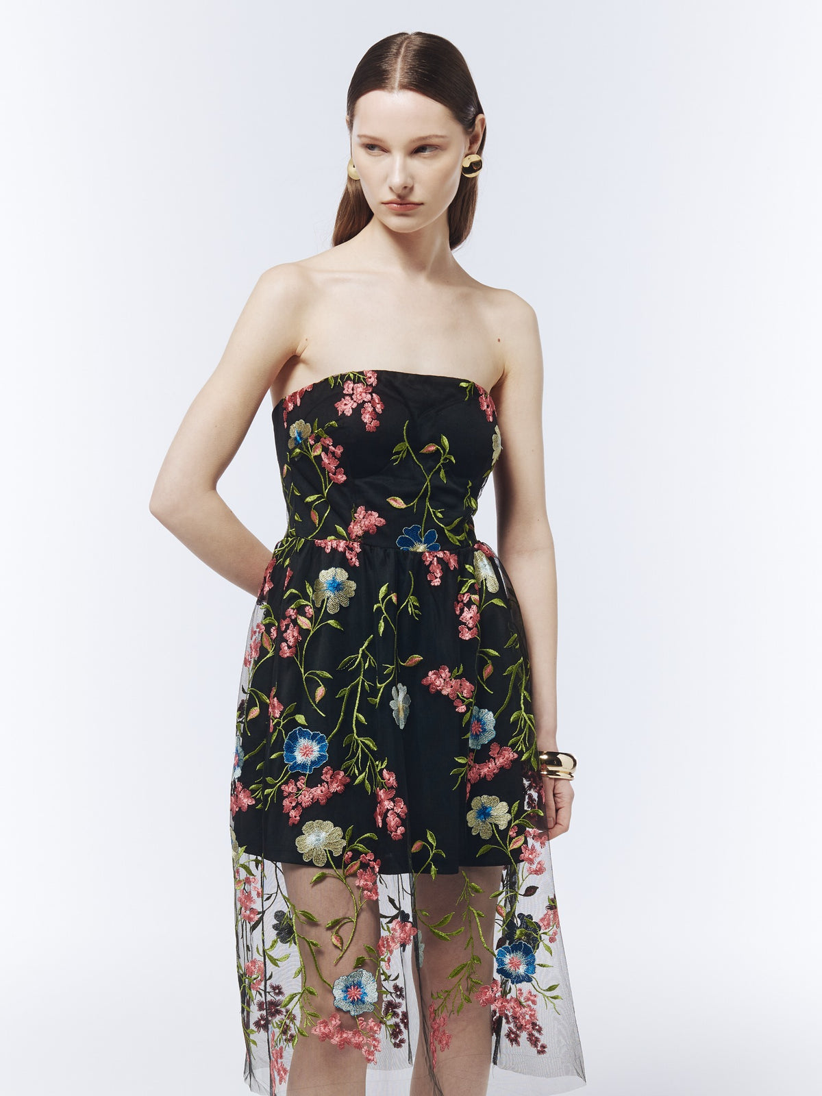 Close-up of the black strapless midi dress showing pink, blue and ivory floral embroidery and the fitted bodice.