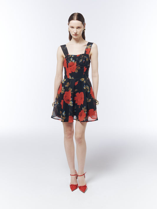 Front full-length model view of the SOUR FIGS Midnight Rose Black floral mini dress, showing the square neckline, fitted waist and flared hem.