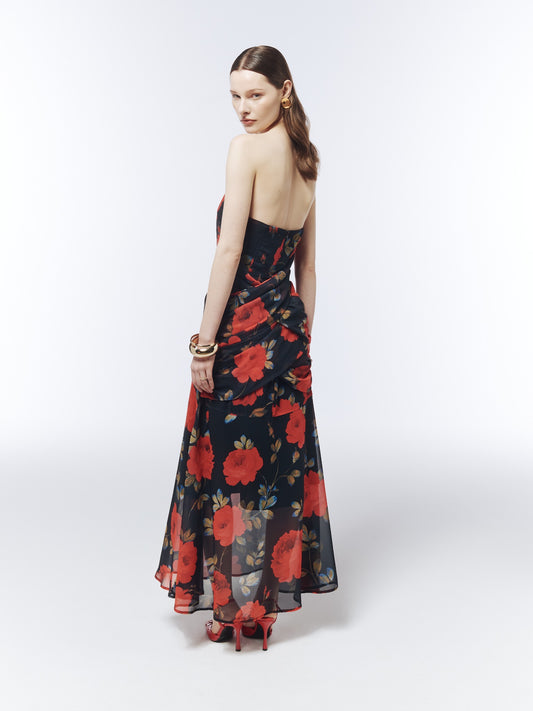 Back model view of the SOUR FIGS Midnight Rose Black floral strapless maxi dress, showing the gathered crossover drape across the hips.