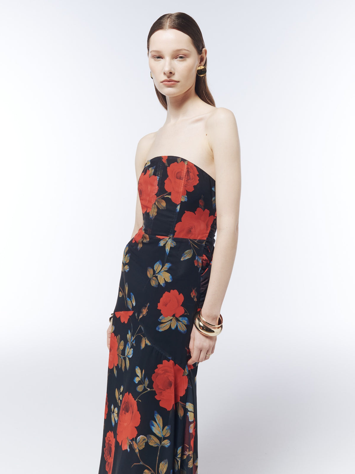 Close-up model view of the SOUR FIGS Midnight Rose Black floral strapless maxi dress, showing the curved neckline, panelled bodice and red rose print.
