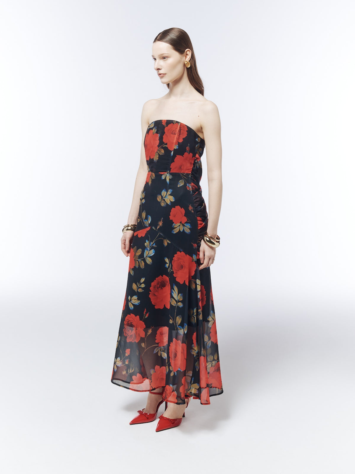 Three-quarter front view of the SOUR FIGS Floral Strapless Draped Maxi Dress in Midnight Rose Black, showing the shaped waist and side gathers.