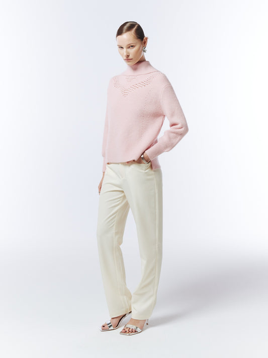 SOUR FIGS blush pink funnel-neck jumper, three-quarter model view showing the openwork yoke and side hem slit.