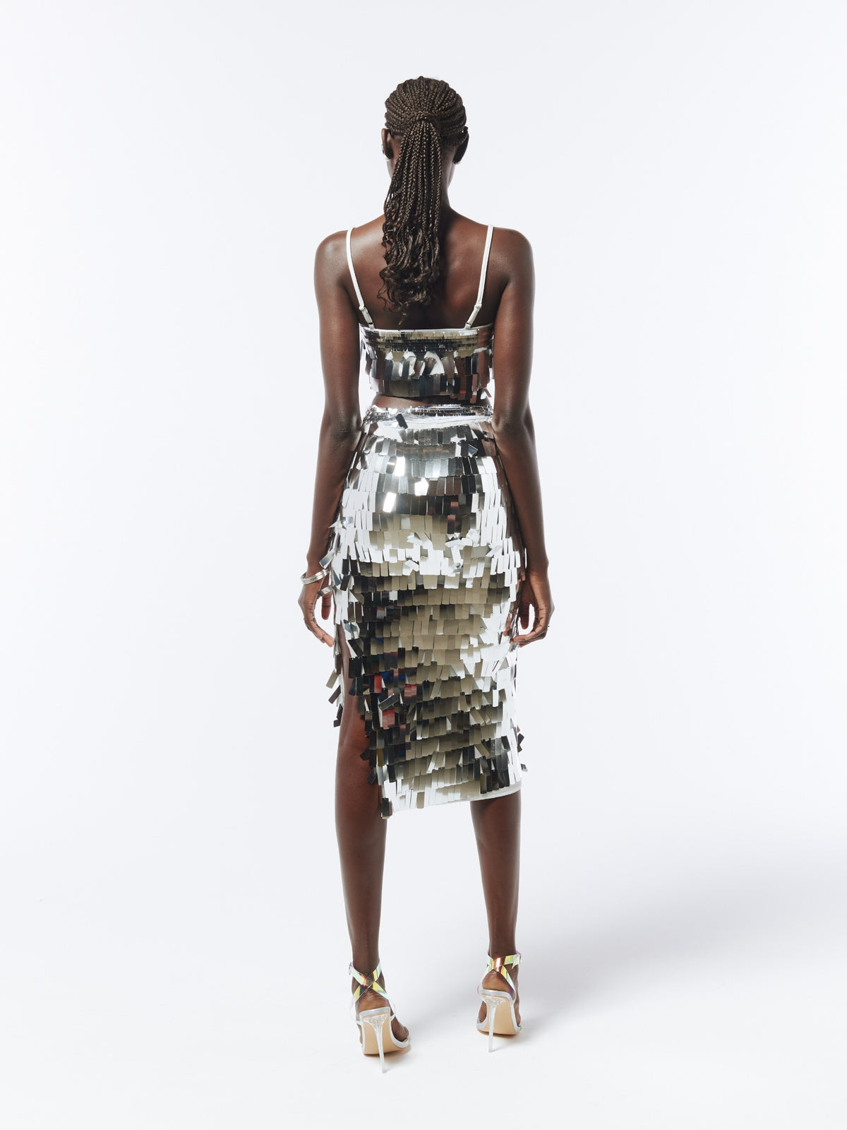 Back model view of the SOUR FIGS silver sequin crop top and midi skirt set, showing adjustable shoulder straps and all-over sequin detailing.