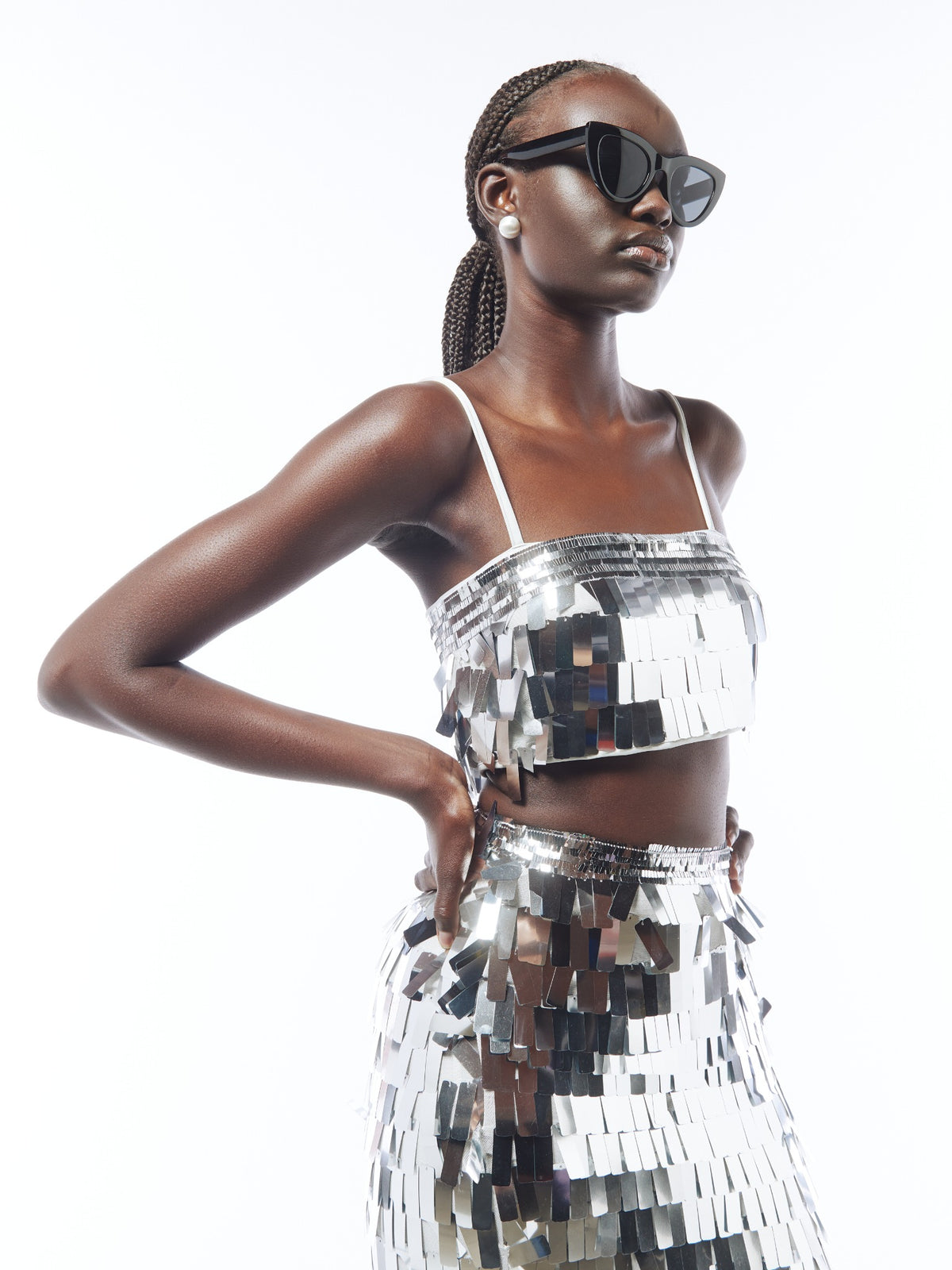 Close-up of the SOUR FIGS silver sequin co-ord set, showing reflective rectangular sequins, the crop top neckline and skirt waistband.
