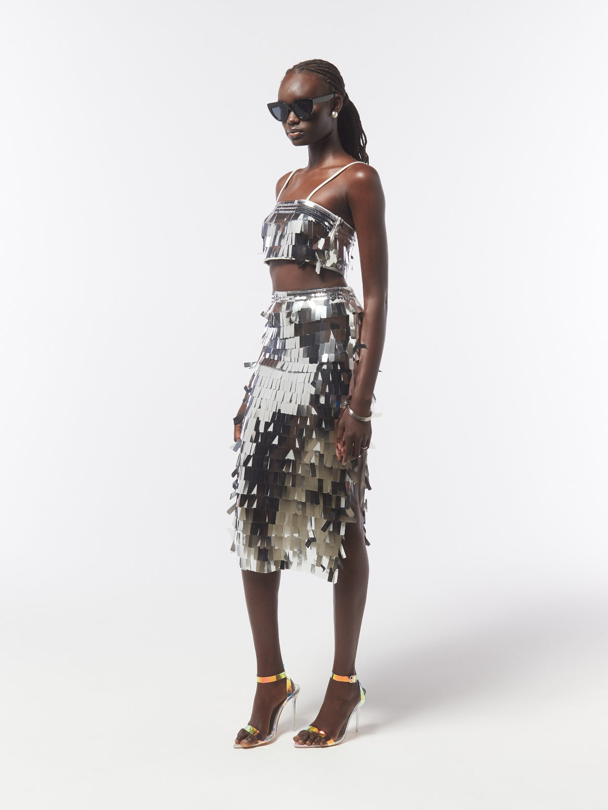 Three-quarter model view of the SOUR FIGS Sequin Crop Top and Midi Skirt Co-Ord Set in Silver, showing layered rectangular sequins and the skirt's side slit.
