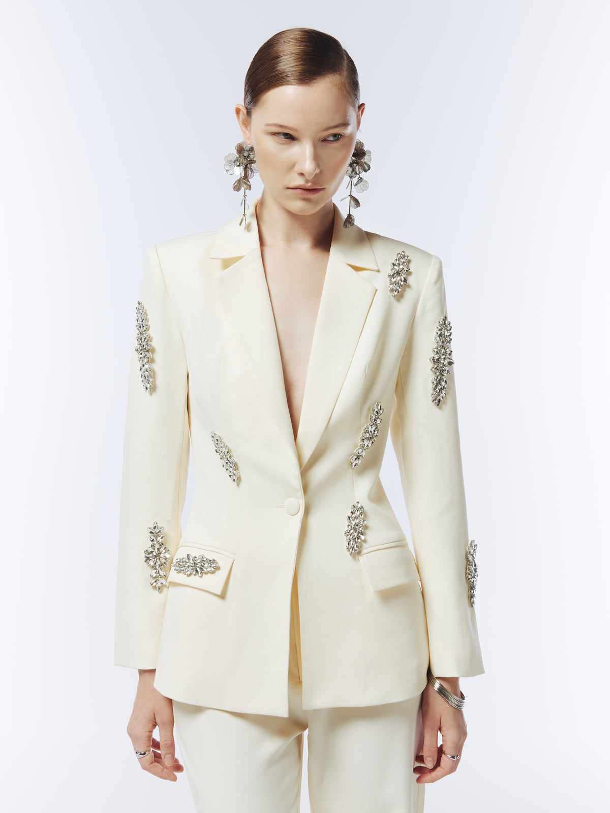 Front detail of SOUR FIGS crystal-embellished single-breasted blazer in soft ivory, showing floral crystal clusters and a shaped waist.